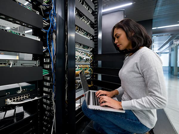 Wholesale broadband Features 600x450 Woman in data center facility typing on a keyboard