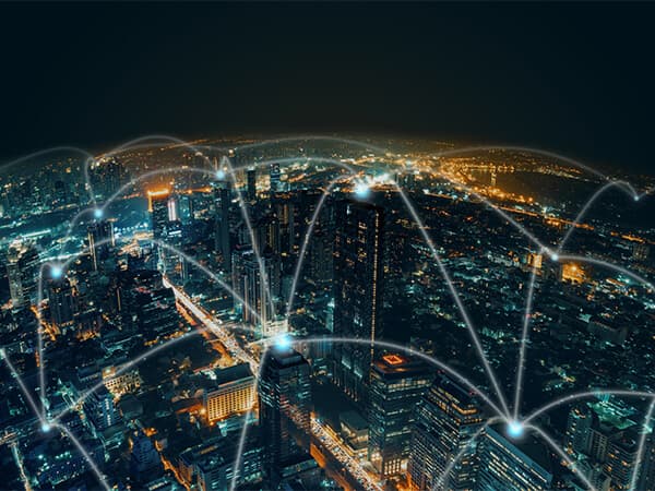 Wholesale Hyperscalers Featured Tiles 600x450 Sky view of large city at night with white lights and dots above the city